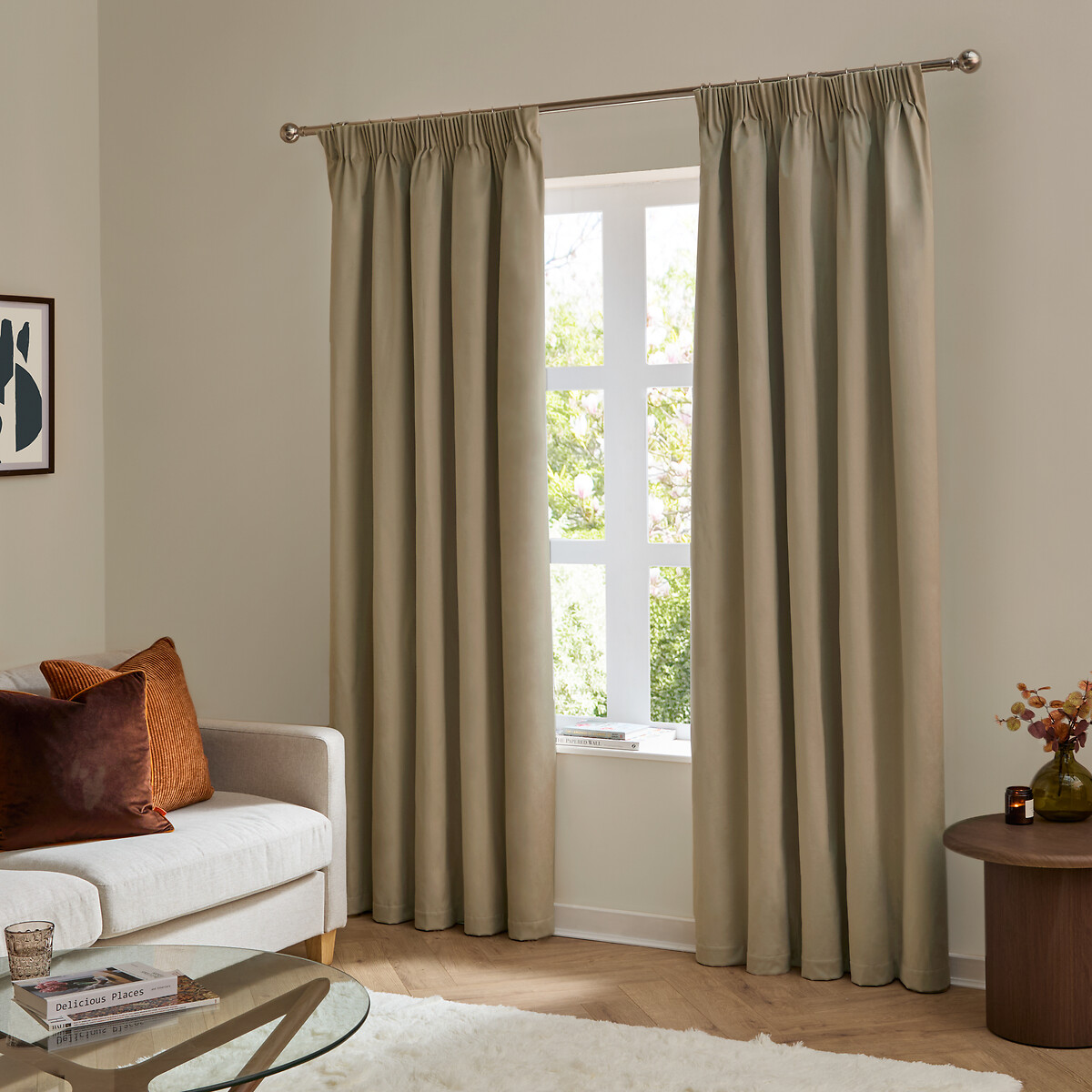 Curtains custom made and stitched by Maple Furnishing House hanging on a rod partially covering a window