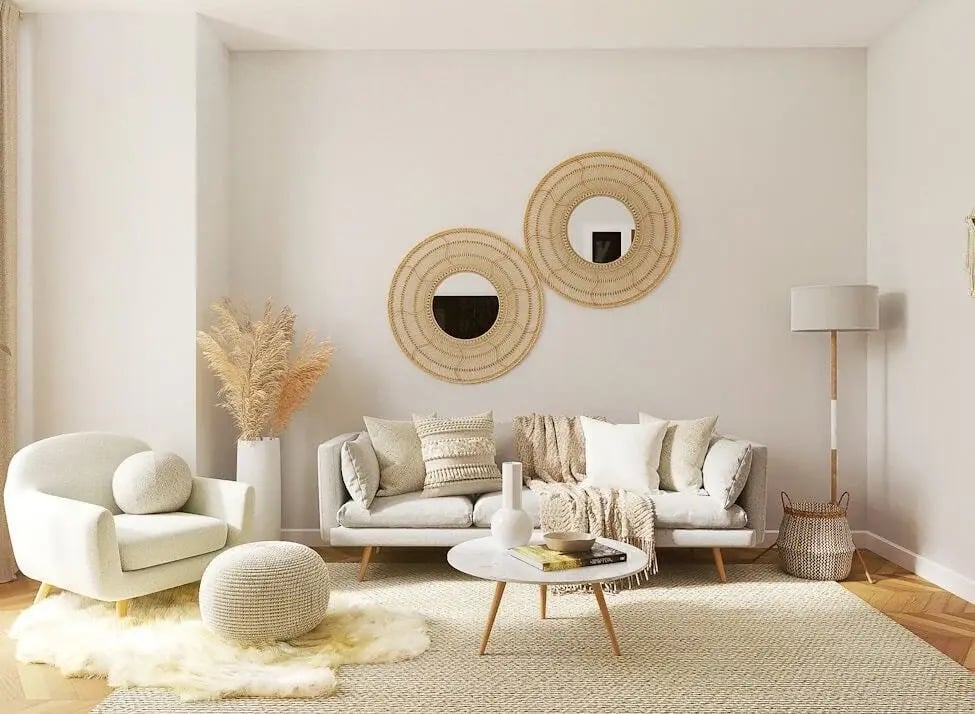 Light grey modern sofa and white armchair on a woven area rug over wooden parquet flooring